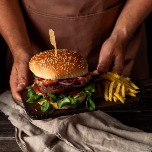 high angle man holding tray with burger fries